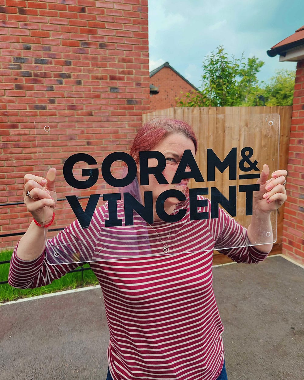 A G&V team member holding the Goram & Vincent sign